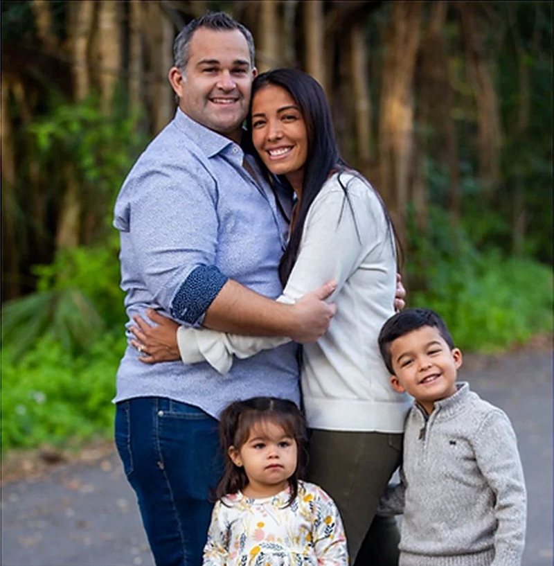 Dr. Christopher Bob with his wife and their two children