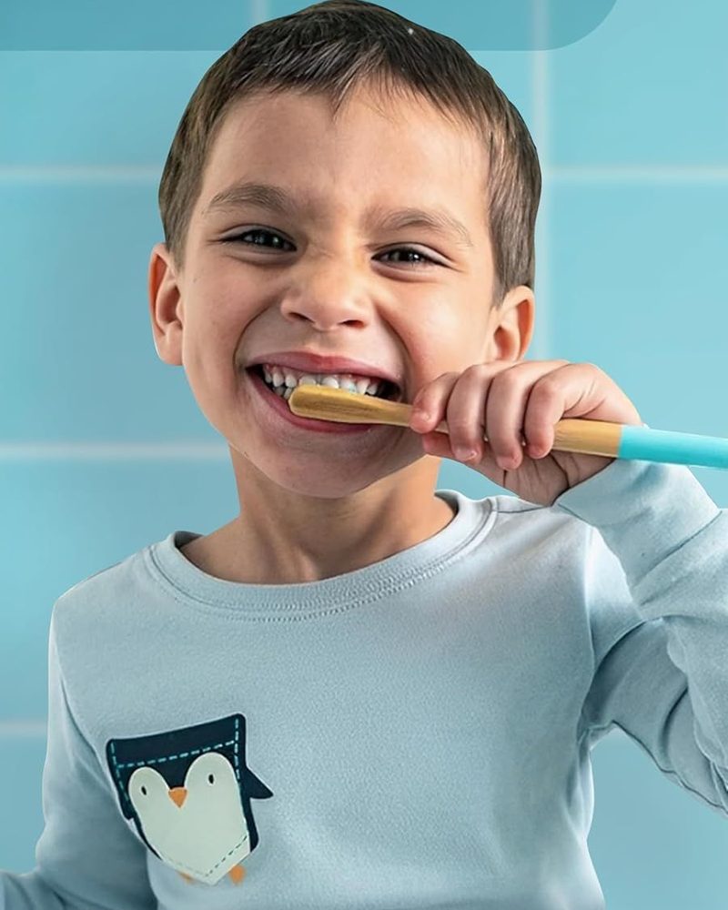 A child brushing with a wooden toothbrush